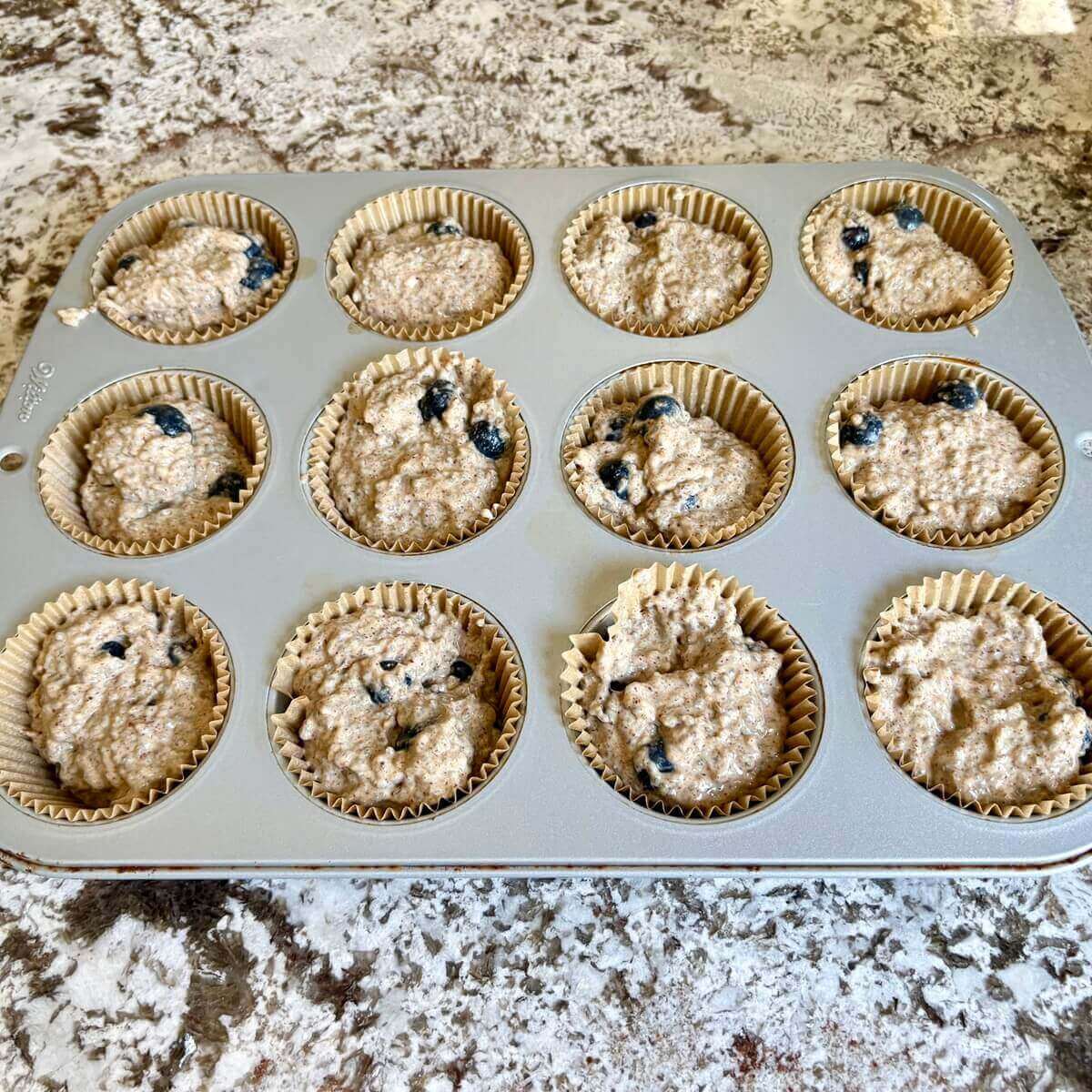 Raw chia muffins in a pan.