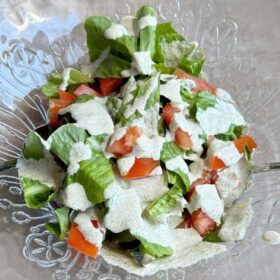 A salad with hemp dressing in a glass bowl.