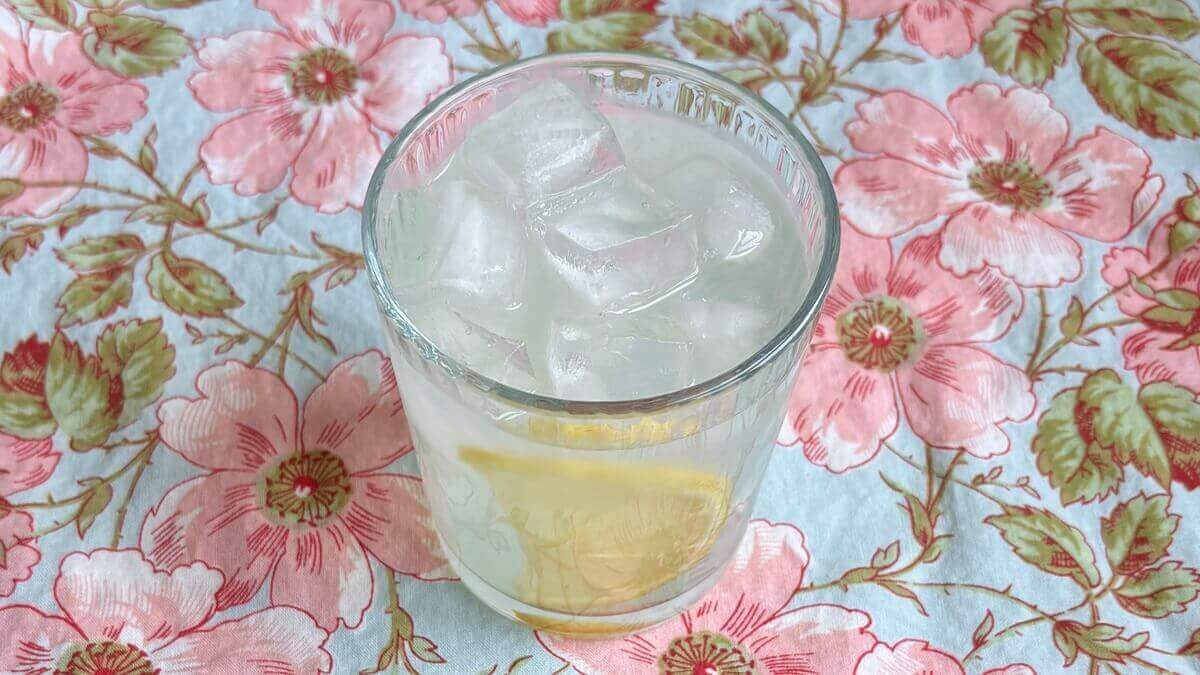 Lemonade in a glass with ice.