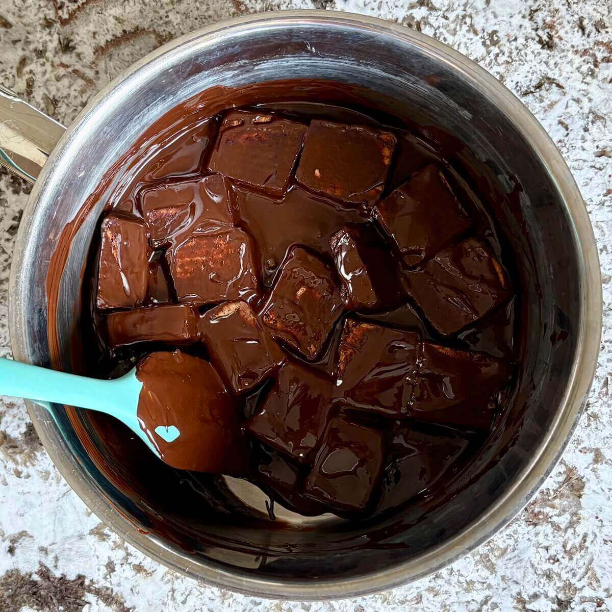 Melted chocolate-coated tofu in a pot.