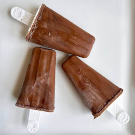 Monk fruit popsicles on a white platter.
