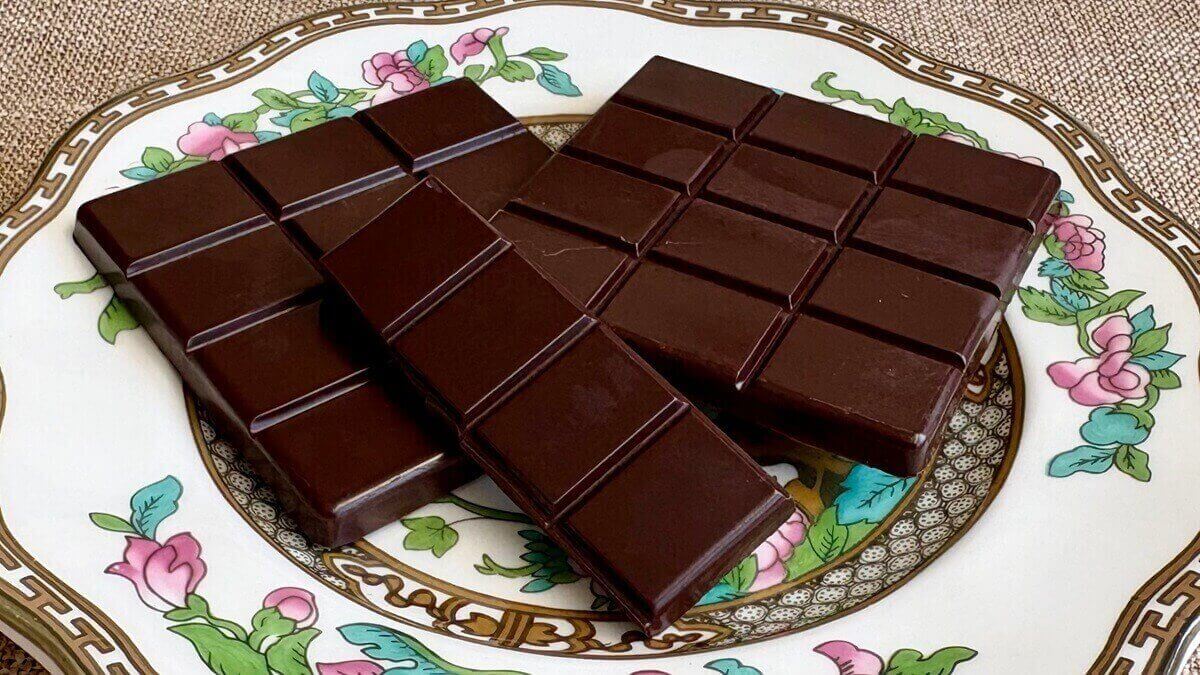Squares of monk fruit sweetened chocolate on a plate.