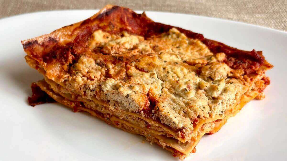 A serving of tofu lasagna on a white plate.