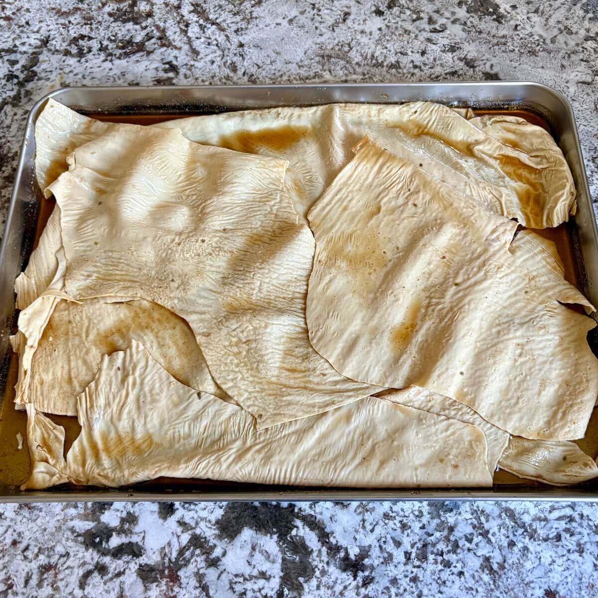 Vegan turkey marinating on a sheet pan.