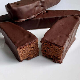 Chocolate dessert seitan slices on a white plate.