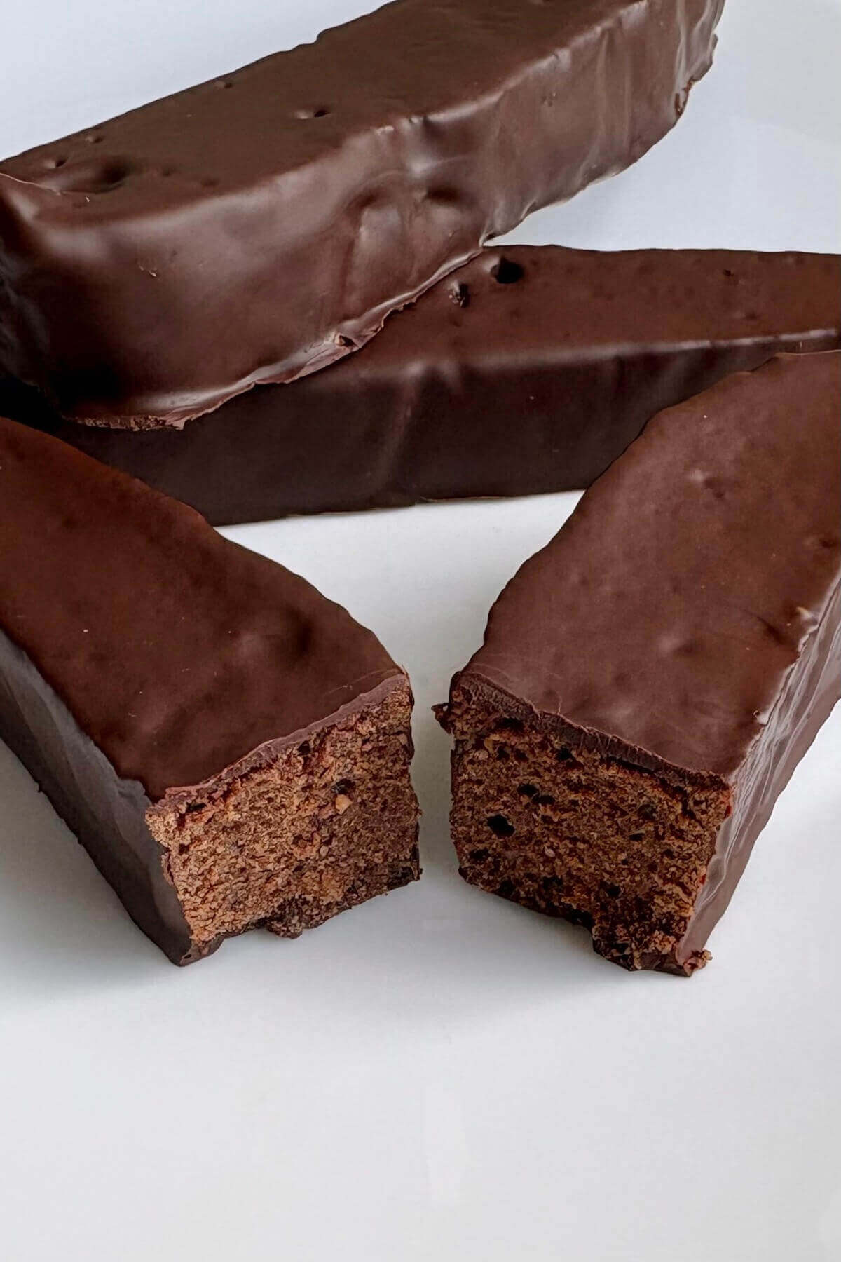 Chocolate seitan slices on a white plate.