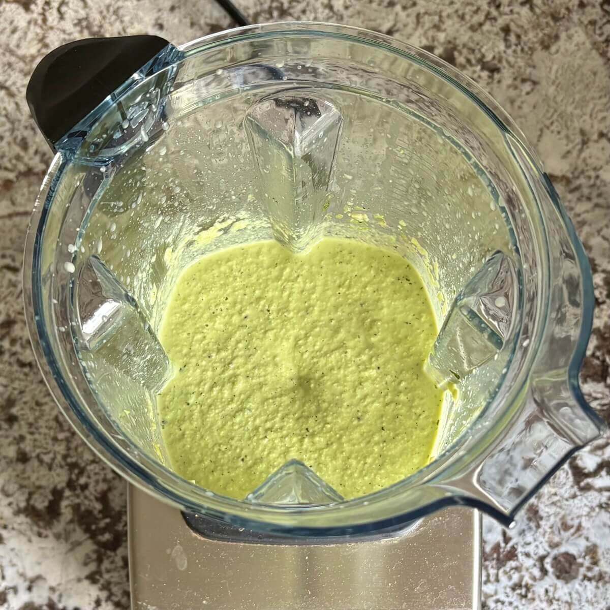 A creamy edamame sauce blended in a blender.