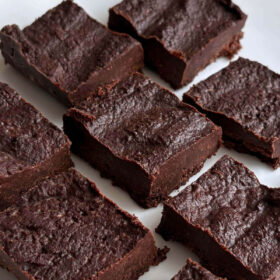 Chocolate flaxseed fudge squares on a white plate.