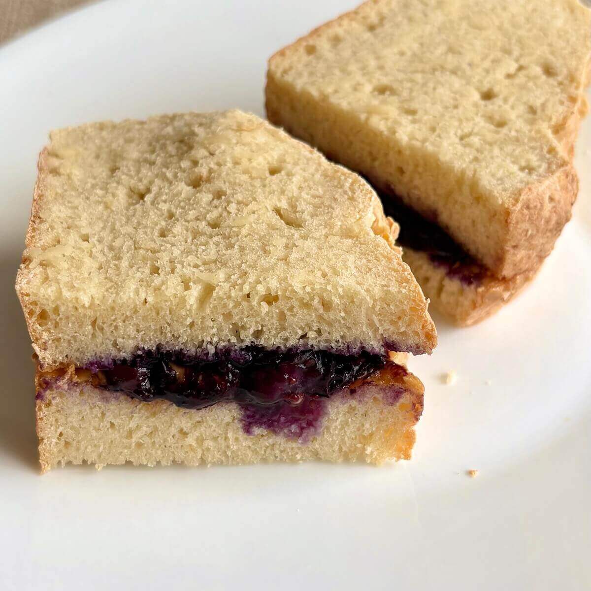 A tofu bread sandwich on a plate.