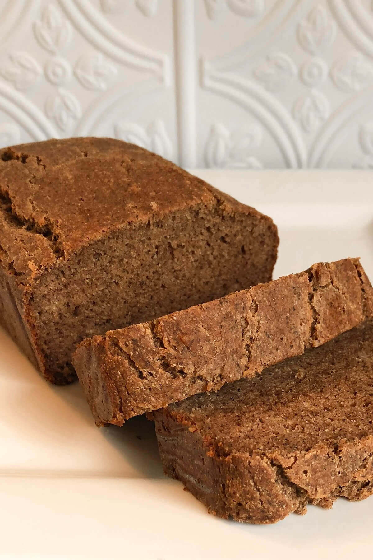 Banana bread on a white platter.
