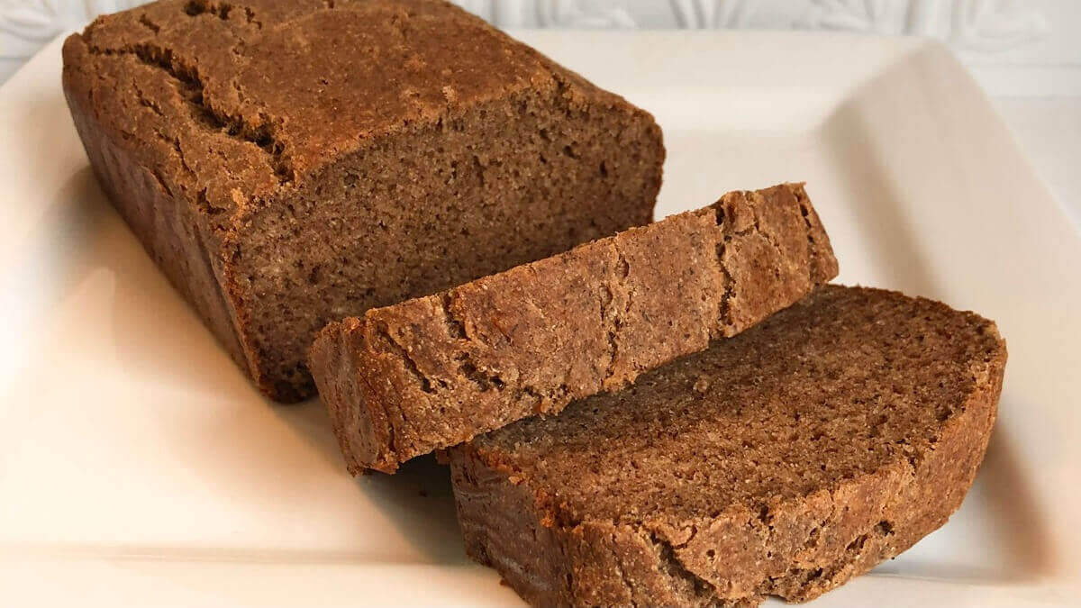 Banana bread made with buckwheat on a white platter.