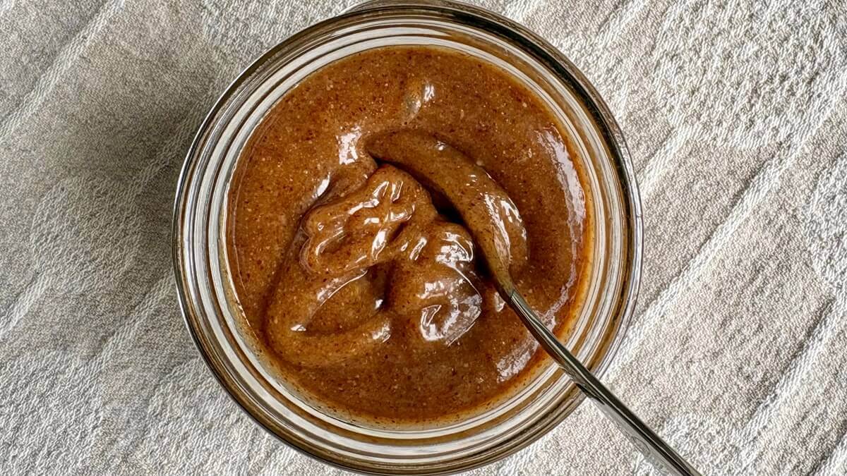 Caramel made with almond butter in a glass jar.