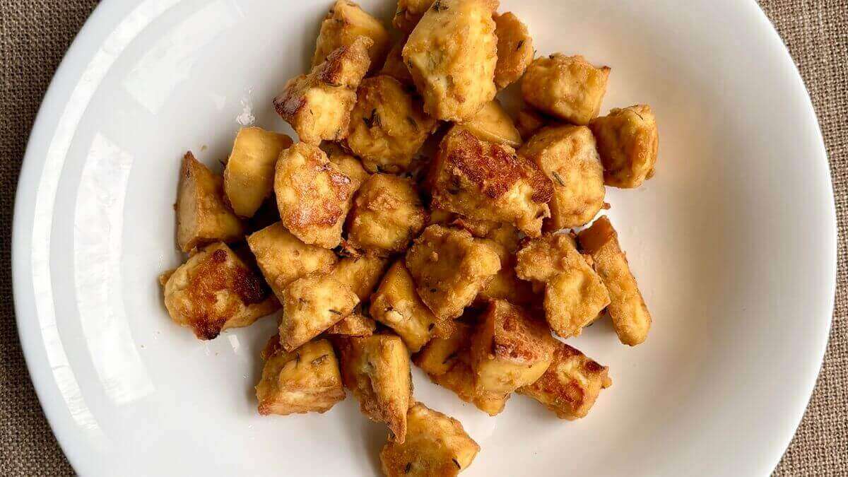 Caramelized pieces of tofu in a bowl.
