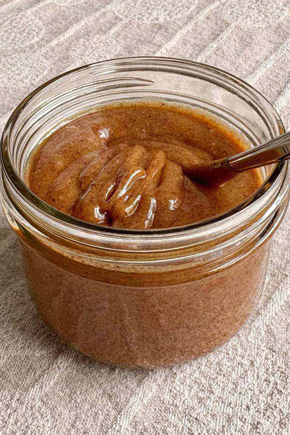 Vegan caramel sauce in a glass mason jar.