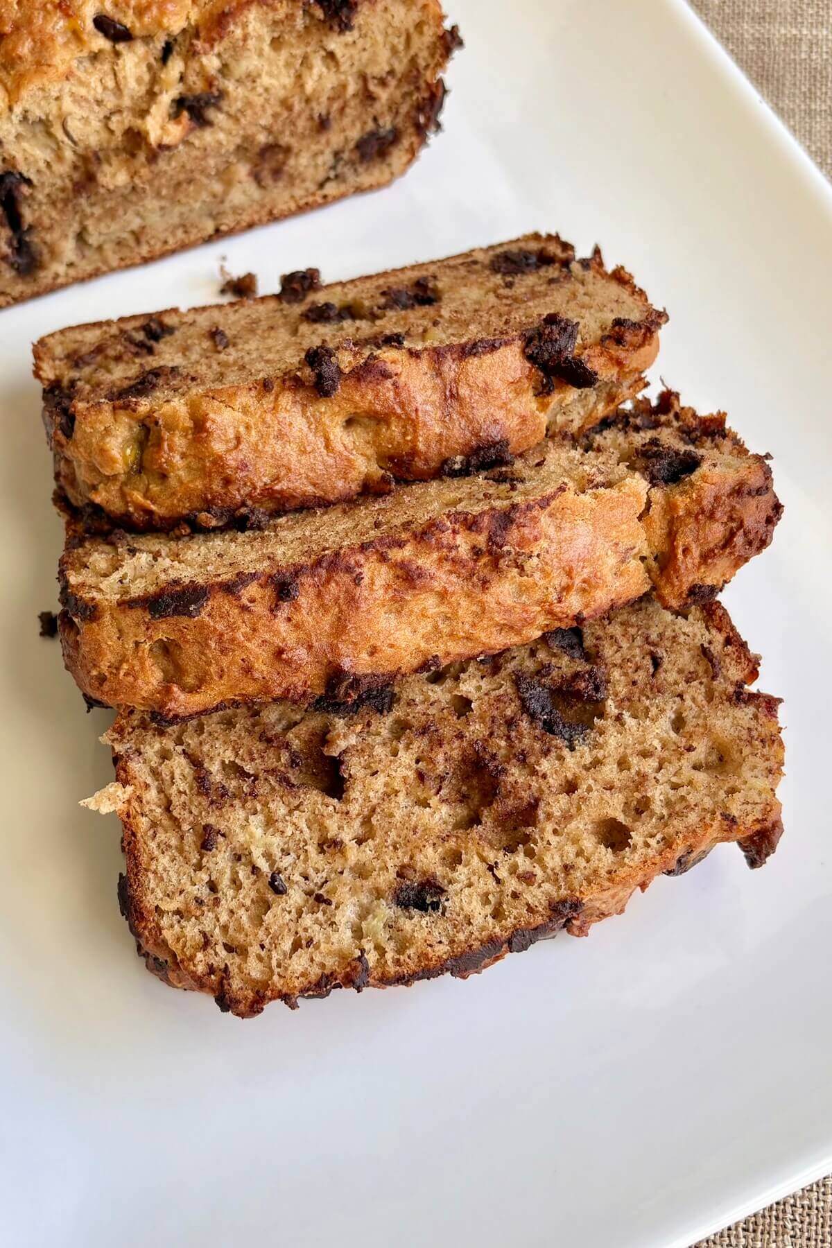 Banana bread seitan slices on a white platter.
