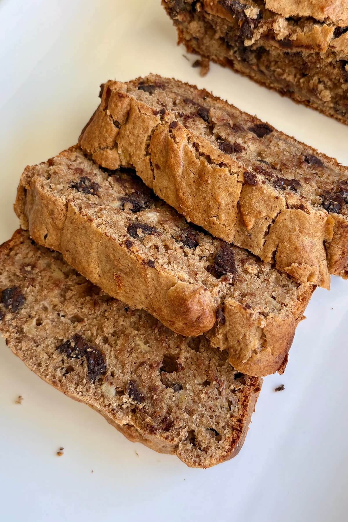 Sliced banana bread made with oat flour on a platter.