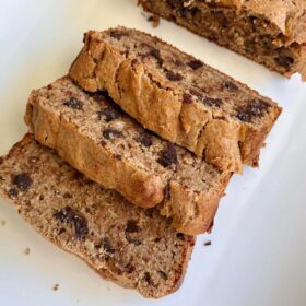 Slices of oat flour banana bread on a white platter.