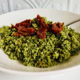 Pesto quinoa in a white bowl.