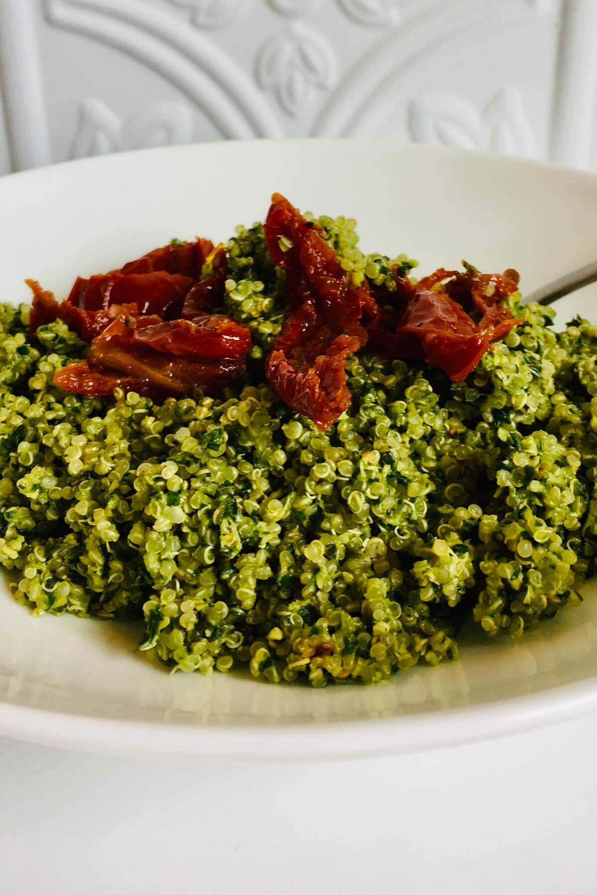 Quinoa with pesto in a bowl.